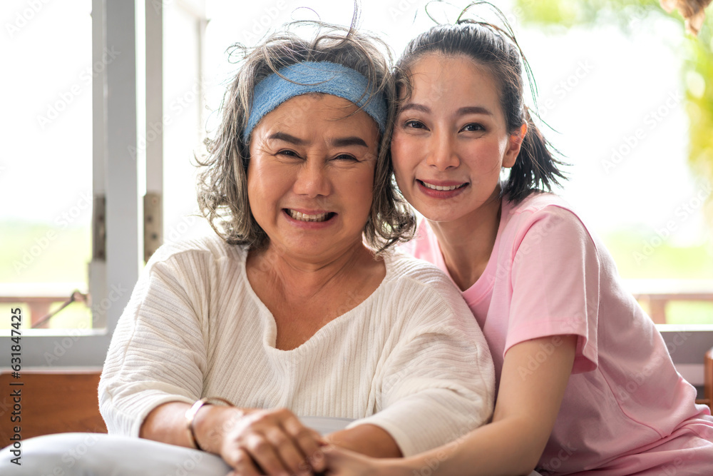 Portrait of enjoy happy love asian family senior mature mother and young daughter smiling play laughing and having fun together at home, care, elderly, insurance.happy family and Mother Day concept Portrait of enjoy happy love asian family senior mature mother and young daughter smiling play laughing and having fun together at home, care, elderly, insurance.happy family and Mother Day concept