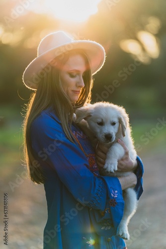 Cheerful Caucasian female enjoying a tender moment with a cuddly Golden Retriever in forest setting