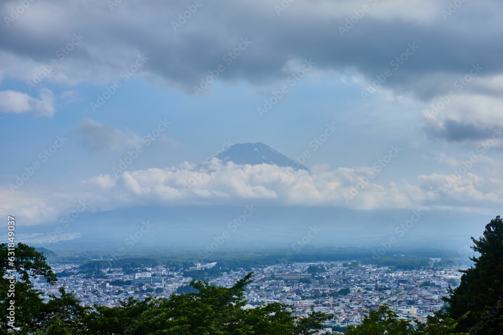 Picturesque landscape of Mount Fuji engulfed by a cloudy summer sky