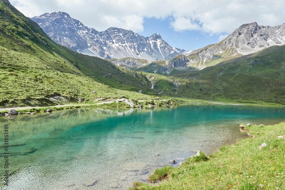 Alpine scenery in Arosa, Switzerland featuring a serene lake surrounded by majestic mountains