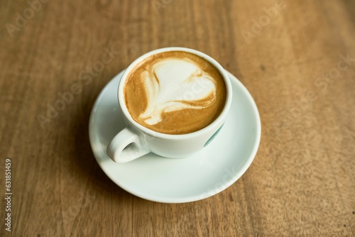 Closeup of a latte macchiato cup on a wooden table