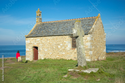 Saint-Samson Chapel and a girl in red, Landunvez city, Breton coast, France, sunny afternoon, close shot photo