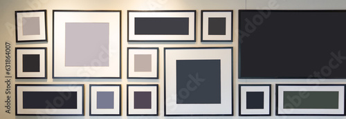 A Wall of Memories: Black, White, and Gray Picture Frames on a White Wall