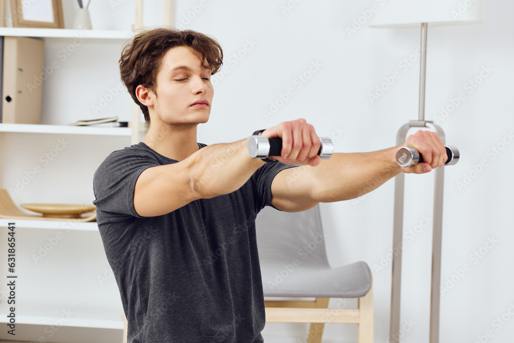 man exercising indoor home sport training gray health lifestyle activity dumbbells man exercising indoor home sport training gray health lifestyle activity dumbbells