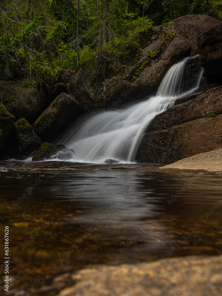 Amazing waterfall hidden deep in Jizera mountains, Czech Republic. Calm and peaceful place with water flowing in cascade river. Amazing waterfall hidden deep in Jizera mountains, Czech Republic. Calm and peaceful place with water flowing in cascade river.