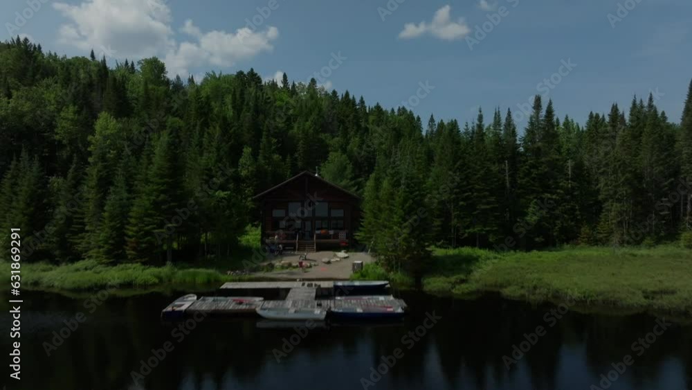 Aerial of a calm lake surrounded by dense calm forest during the early morning Aerial of a calm lake surrounded by dense calm forest during the early morning