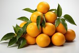 A lot of orange and fresh tangerines lies on a white background, close-up. They grow green twigs with leaves. Winter holidays. Christmas mood
