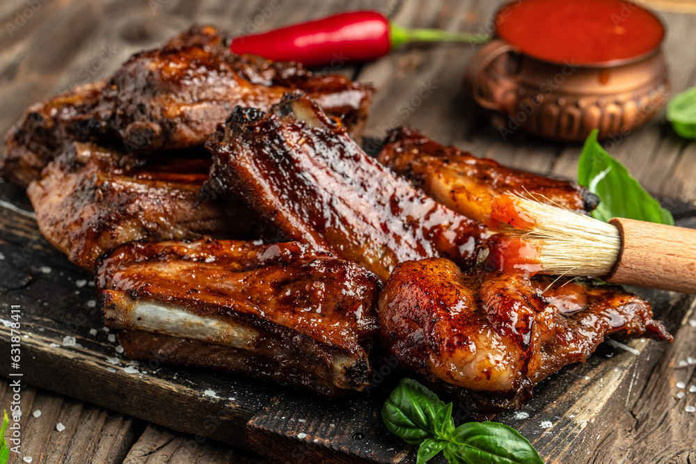 Delicious grilled pork ribs in BBQ sauce. Food recipe background. Close up