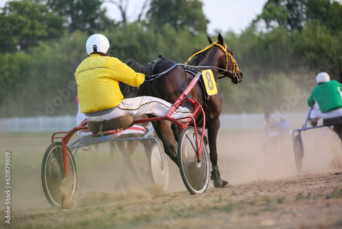 Horses and riders running at horse races