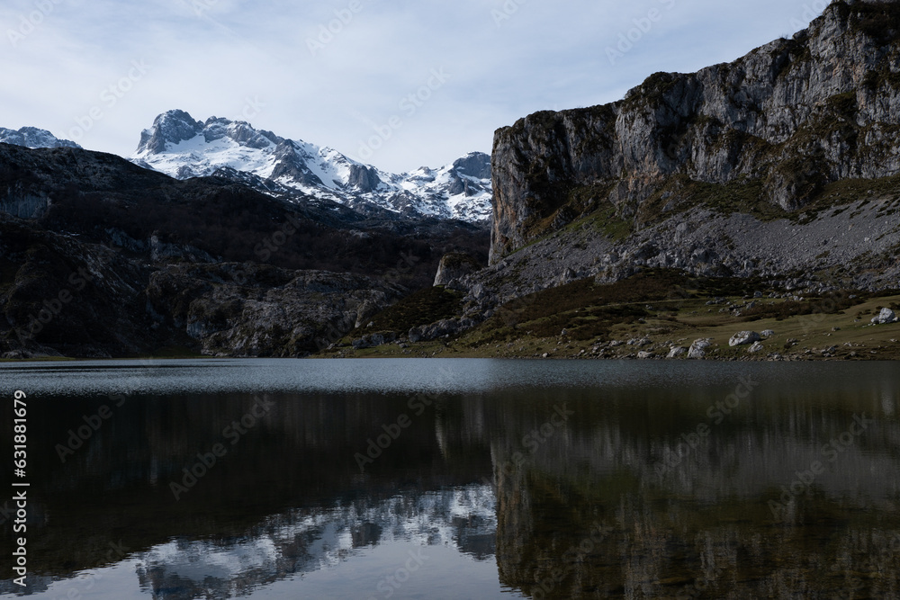 Panoramic view of mountains reflected on the water with clouds