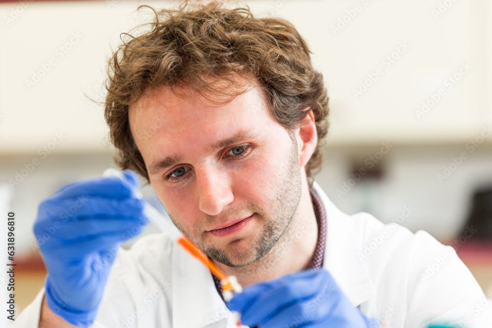 Young scientist in a research laboratory creating a scientific experiment, laboratory concept Young scientist in a research laboratory creating a scientific experiment, laboratory concept