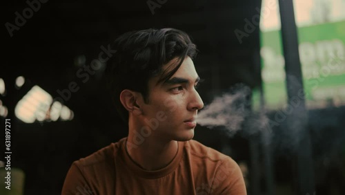 Young boy smoking vape
