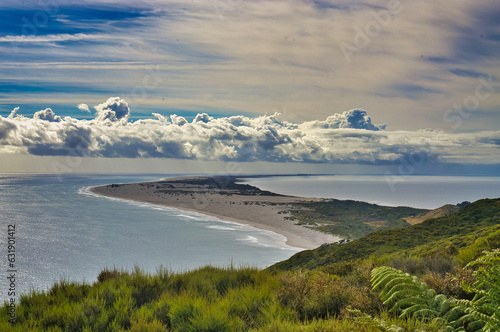 Aerial view of Farewell Spit, a crescent-shaped promontory made up of dunes in the northernmost part of South Island, one of the most important bird sanctuaries in New Zealand
 photo