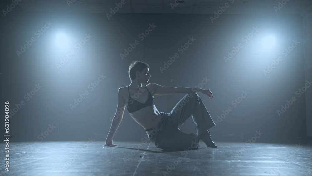 Graceful female dancing in studio with smoke and spotlight. Attractive talented woman dancing in studio. Slow motion in 4K, UHD Graceful female dancing in studio with smoke and spotlight. Attractive talented woman dancing in studio. Slow motion in 4K, UHD
