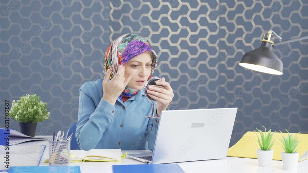 Hijab business woman looking at his wrinkled and rough skin. Hijab business woman looking at his wrinkled and rough skin.