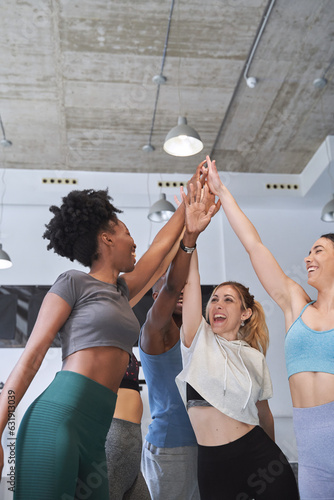Group of sporty people celebrating after training together in the gym. Sport and healthy lifestyle concept.