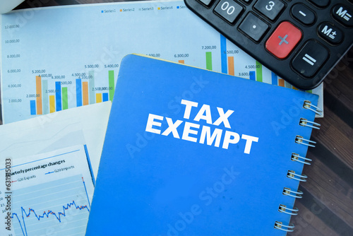 Concept of Tax Exempt write on book isolated on Wooden Table.
