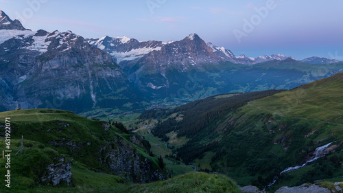 View on the Eiger Nordwand and other famous Swiss Alpine mountains during sunrise on a summer morning  as seen from the mountain hut First on First mountain. early morning sunrise in Switzerland.