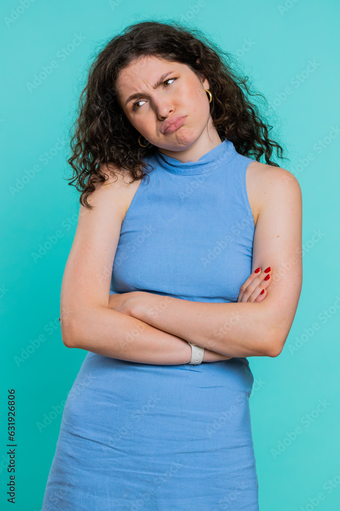 Sad woman feeling hopelessness loneliness, nervous breakdown, loses becoming surprised by lottery results, bad fortune, loss unlucky news. Young adult girl isolated on studio blue background. Vertical Sad woman feeling hopelessness loneliness, nervous breakdown, loses becoming surprised by lottery results, bad fortune, loss unlucky news. Young adult girl isolated on studio blue background. Vertical