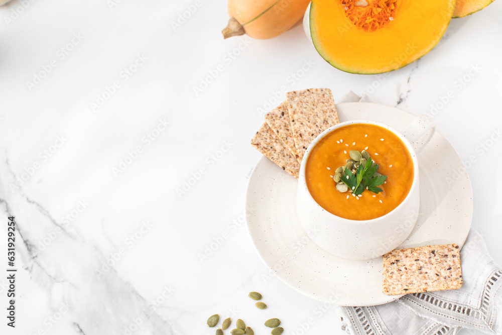 A mug of warm pumpkin soup. The concept of the autumn menu. Autumn recipes. Copy space A mug of warm pumpkin soup. The concept of the autumn menu. Autumn recipes. Copy space