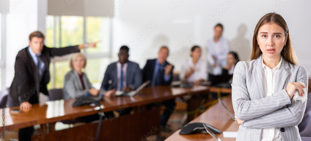 Εκτύπωση καμβά Portrait of upset adult woman in meeting room against the backdrop of dissatisfi