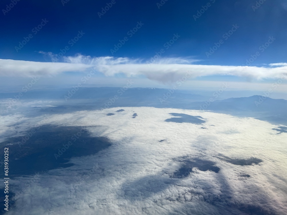 Aerial view of indigo blue skies and low clouds over the Santa Ana Mountains in southern California