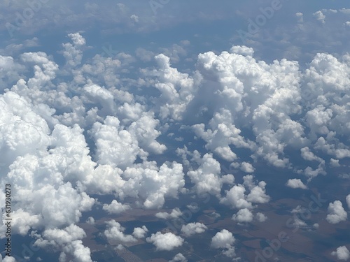 Aerial view looking down on small, puffy clouds above Eden, Texas