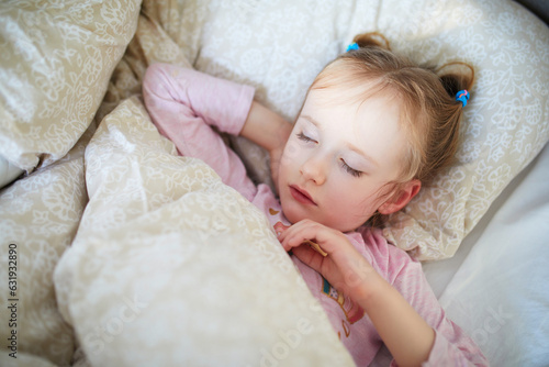 Little child sleeping in bed photo