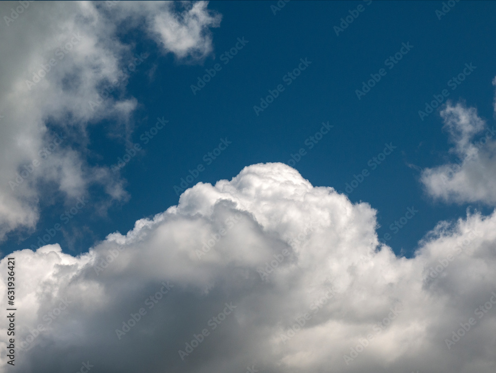 White clouds over blue sky background. Fluffy cumulus cloudscape shape White clouds over blue sky background. Fluffy cumulus cloudscape shape