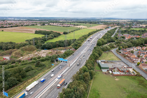 Aerial photo of the village of East Ardsley in the City of Leeds metropolitan borough, in West Yorkshire, England showing a typical British housing estate along side a busy motorway highway