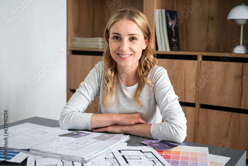 Portrait of smiling young interior designer at home working place