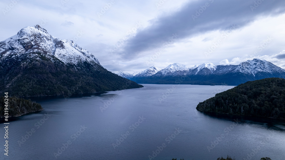 Beautiful chain of snowy mountains and a lake with blue sky above in Bariloche Argentina, amazing panoramic view at Circuito Chico Patagonia Beautiful chain of snowy mountains and a lake with blue sky above in Bariloche Argentina, amazing panoramic view at Circuito Chico Patagonia