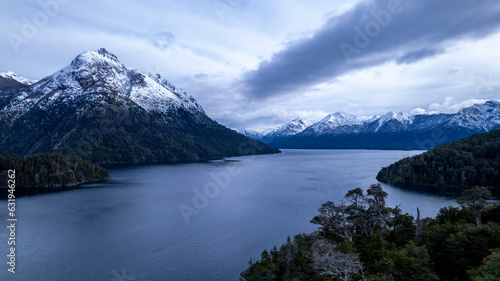 Beautiful chain of snowy mountains and a lake with blue sky above in Bariloche Argentina, amazing panoramic view at Circuito Chico Patagonia