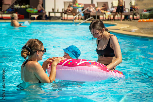 Children with mom have fun in the pool on a hot summer day. © Валентина Хруслова