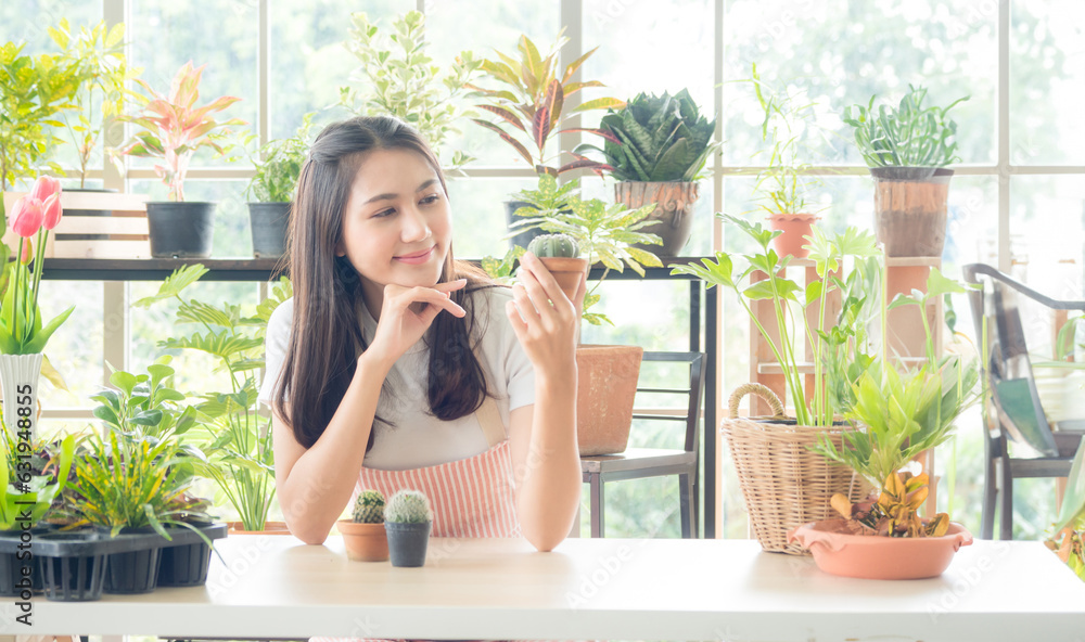 Portrait garden beautiful pretty young Asian girl woman wearing white blouse with long black hair and smile fresh with bright smile look pot small tree leaf green plant in room shop Happy and relax Portrait garden beautiful pretty young Asian girl woman wearing white blouse with long black hair and smile fresh with bright smile look pot small tree leaf green plant in room shop Happy and relax
