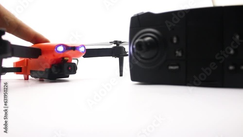 Orange drone with camera and remote control