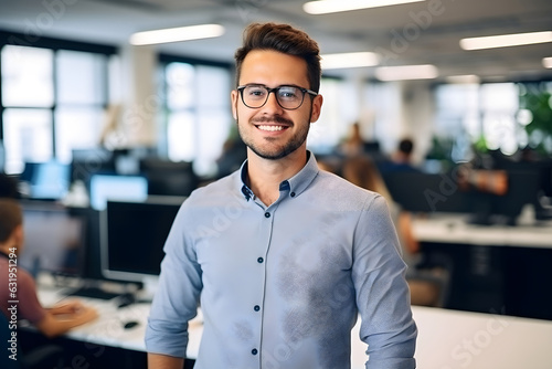 Portrait of hispanic successful young male businessman standing business office blur background. Successful businessman in shirt looking at camera with crossed arms. © PrettyStock