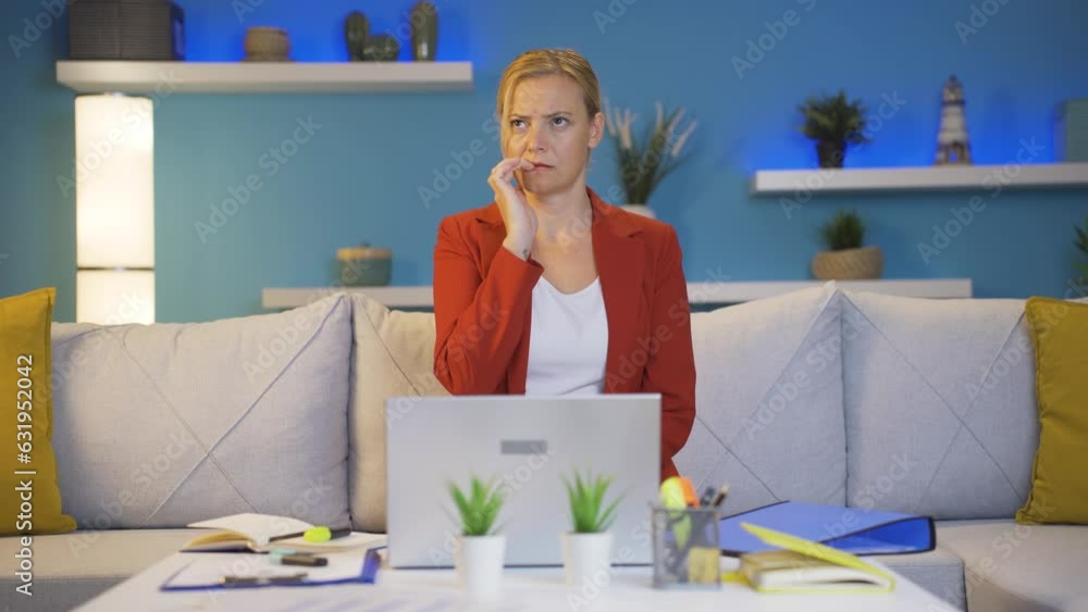 Home office worker woman biting her nails looking at camera. Home office worker woman biting her nails looking at camera.