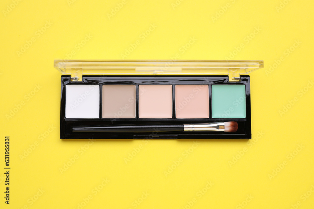 Contouring palette on yellow background, top view. Professional cosmetic product Contouring palette on yellow background, top view. Professional cosmetic product