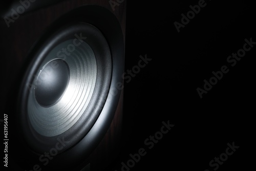 One sound speaker on black background, closeup. Space for text