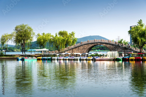 Small bridge and pleasure boats in an outdoor park in the city