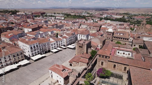 Aerial orbit around empty city square and Torre de Bujaco in Caceres, Spain photo