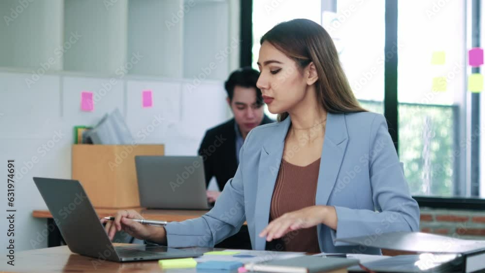 Businesswoman Sitting at Desk Working on Laptop Computer in modern Office. Businesswoman Sitting at Desk Working on Laptop Computer in modern Office.
