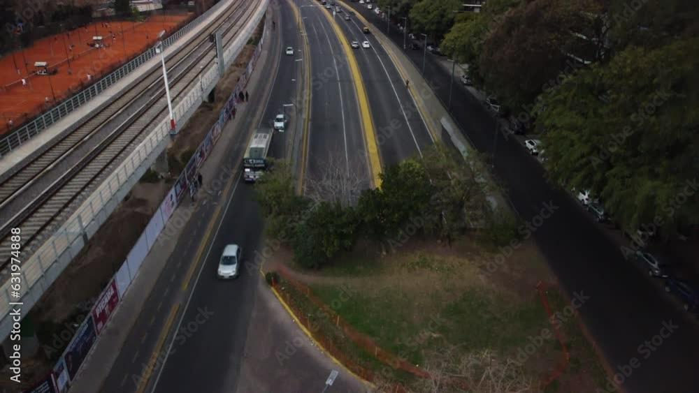The drone flies up over the track, parallel to the railway bridge and the tennis court, Buenos Aires, cloudy The drone flies up over the track, parallel to the railway bridge and the tennis court, Buenos Aires, cloudy