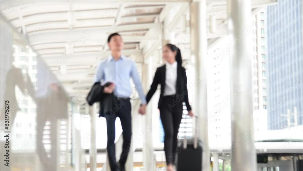 Businesspeople couple lover walking with luggage in business trip. Honeymoon business trip hug together on boarding arrival terminal. Business travel trip holding suitcase at airport couple traveller