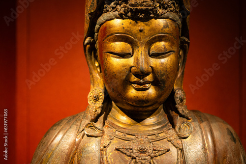 Statue of the buddha over the red background