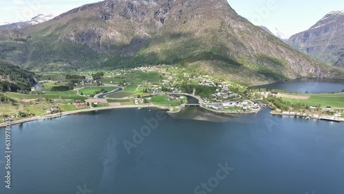 Idyllic Skjolden in the end of Sognefjorden Norway with Sognefjellet mountain in background - Springtime sunny day aerial from seaside photo