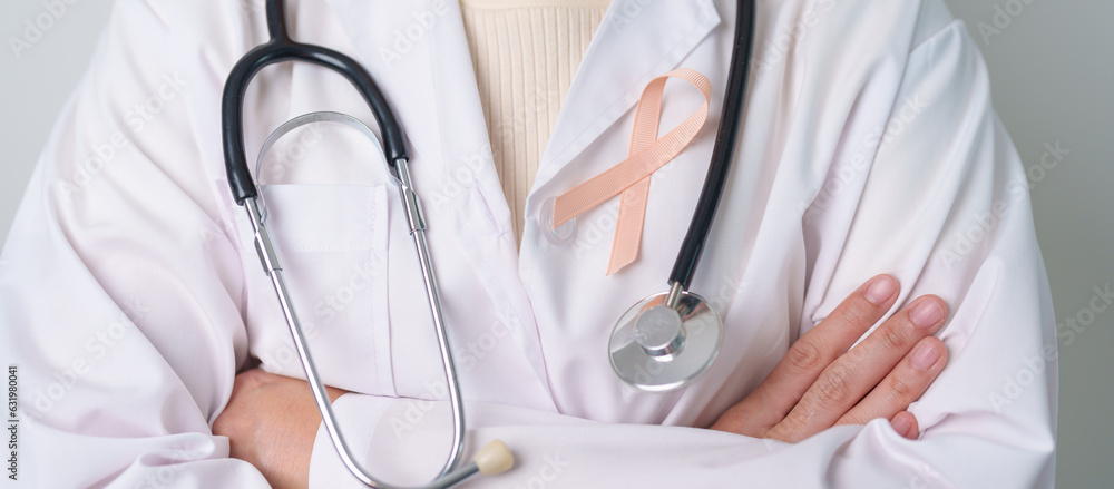 Peach Ribbon for September Uterine Cancer Awareness month. Healthcare and World cancer day concept Peach Ribbon for September Uterine Cancer Awareness month. Healthcare and World cancer day concept