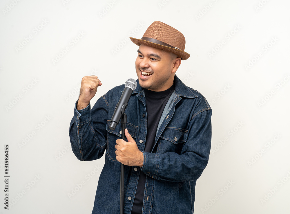 Happiness young asian man singing song. Artist vocalist singer on isolated background. Confident man public speaking talking with microphone in studio. Happiness young asian man singing song. Artist vocalist singer on isolated background. Confident man public speaking talking with microphone in studio.