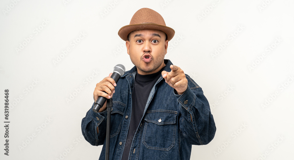 Happiness young asian man singing song. Artist vocalist singer on isolated background. Confident man public speaking talking with microphone in studio. Happiness young asian man singing song. Artist vocalist singer on isolated background. Confident man public speaking talking with microphone in studio.